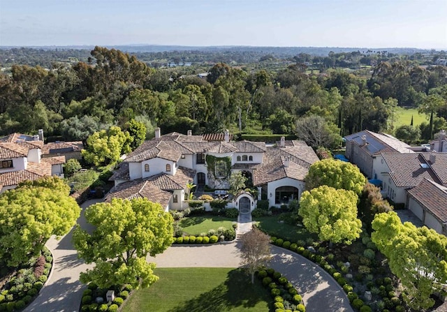 birds eye view of property with a view of trees