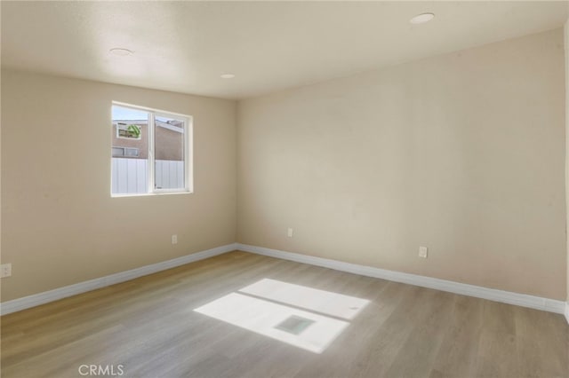 empty room with light hardwood / wood-style floors