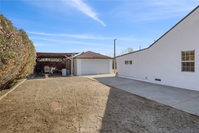 exterior space featuring an outbuilding, a carport, and a garage