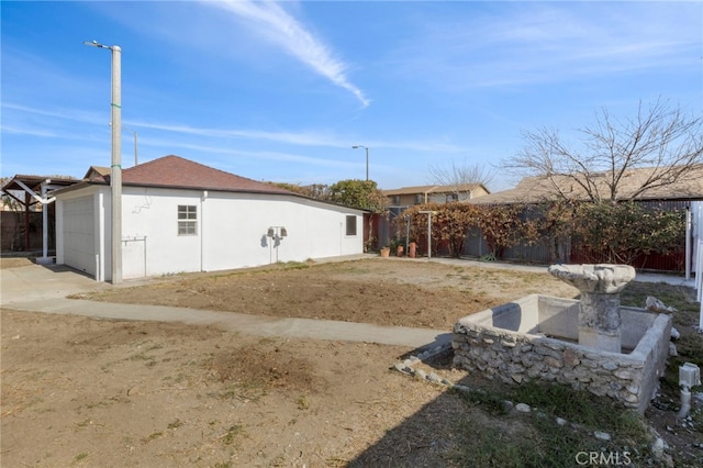 rear view of house with a garage and an outdoor structure