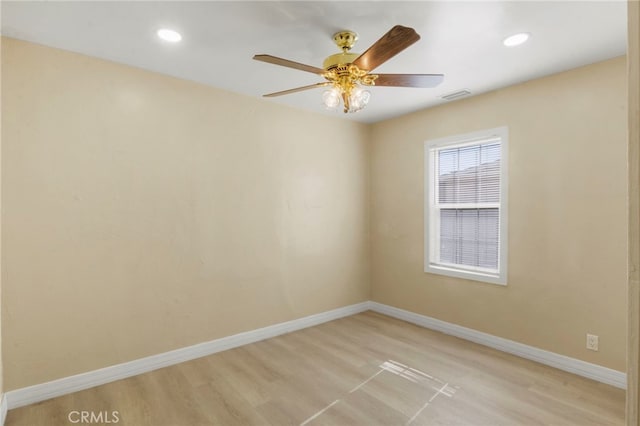 unfurnished room with ceiling fan and light wood-type flooring