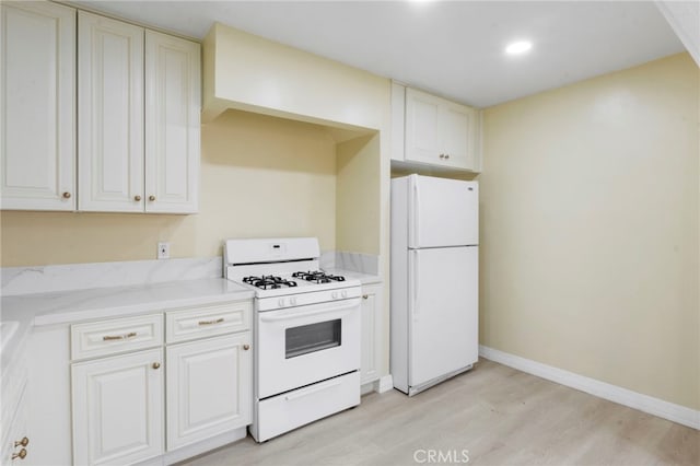 kitchen featuring white cabinetry, white appliances, and light wood-type flooring