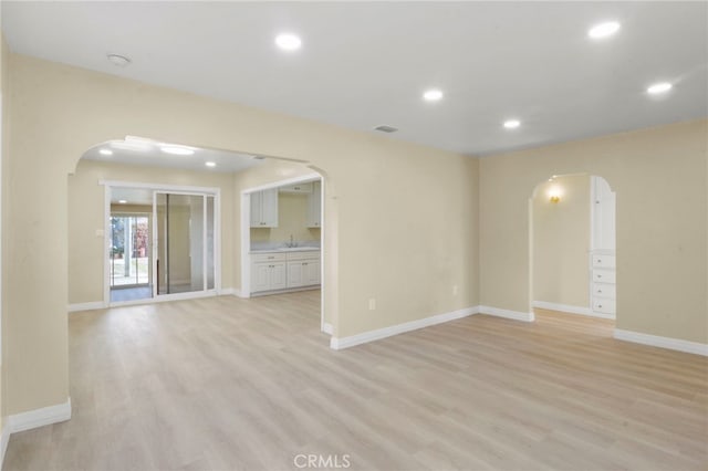 empty room with sink and light hardwood / wood-style flooring