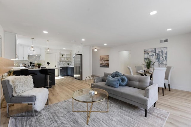 living room with light hardwood / wood-style flooring