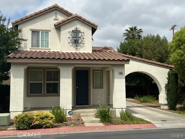 mediterranean / spanish-style home with central air condition unit