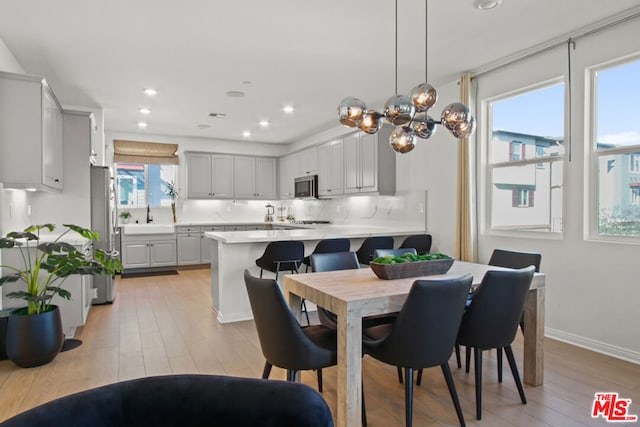 dining space featuring light hardwood / wood-style floors and sink