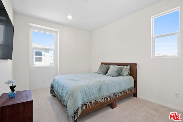 bedroom featuring light colored carpet