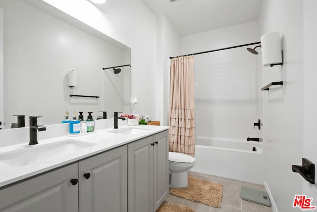 full bathroom with vanity, shower / bath combination with curtain, tile patterned floors, and toilet