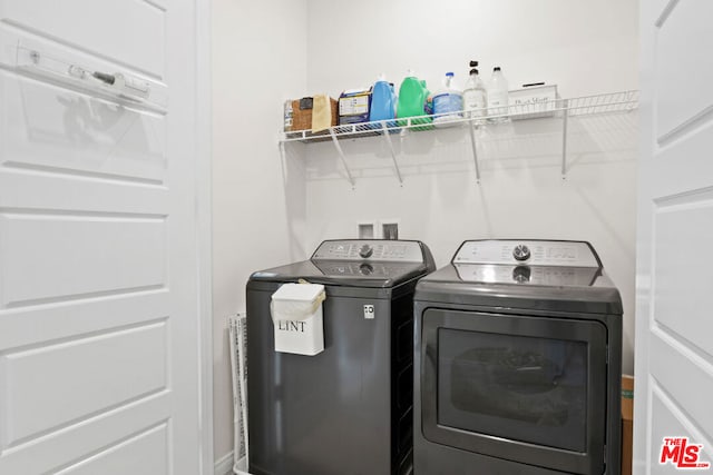 clothes washing area with washer and dryer