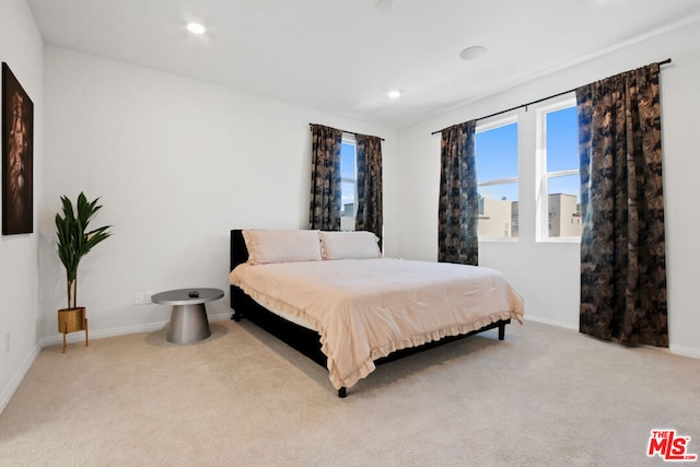 bedroom featuring light carpet