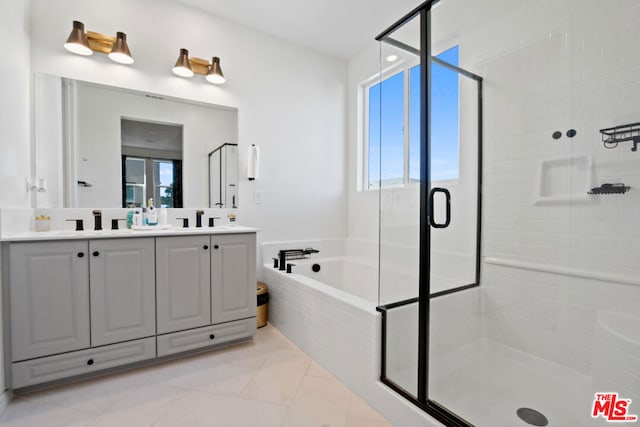 bathroom with tile patterned floors, vanity, and separate shower and tub