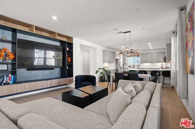 living room featuring a notable chandelier and hardwood / wood-style flooring