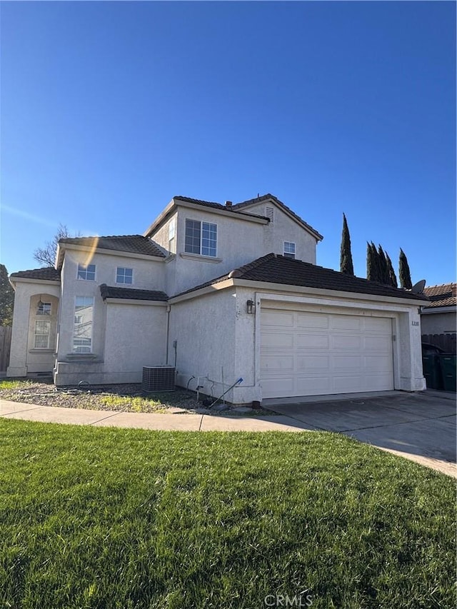 view of front of property with cooling unit, a garage, and a front lawn