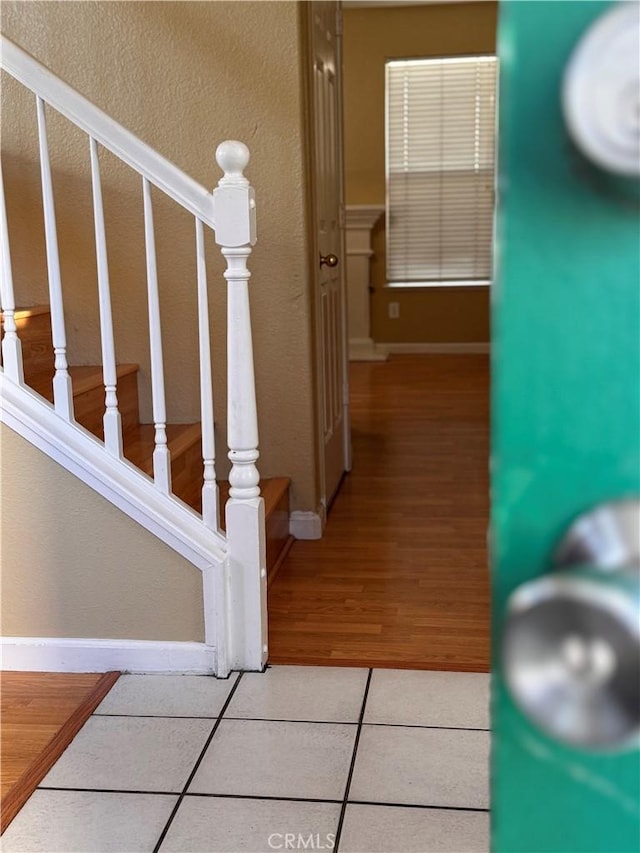 stairway with tile patterned flooring