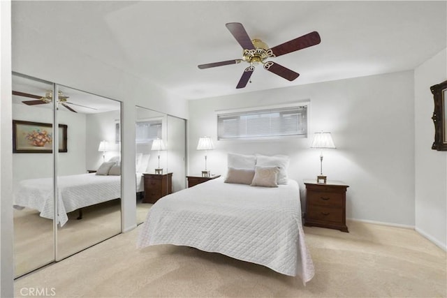 carpeted bedroom with multiple closets and ceiling fan