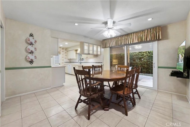 tiled dining space featuring ceiling fan