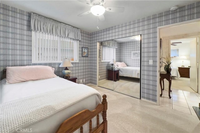 bedroom with ceiling fan and a closet