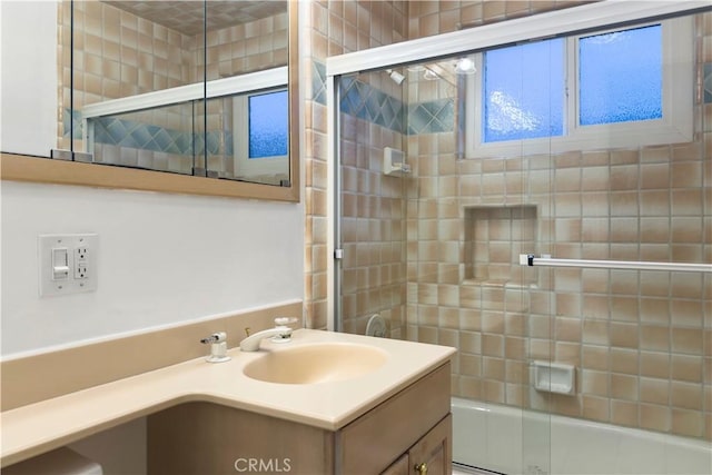 bathroom with vanity and enclosed tub / shower combo