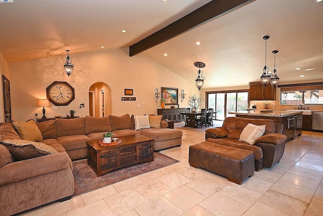 living room with high vaulted ceiling, sink, and beam ceiling