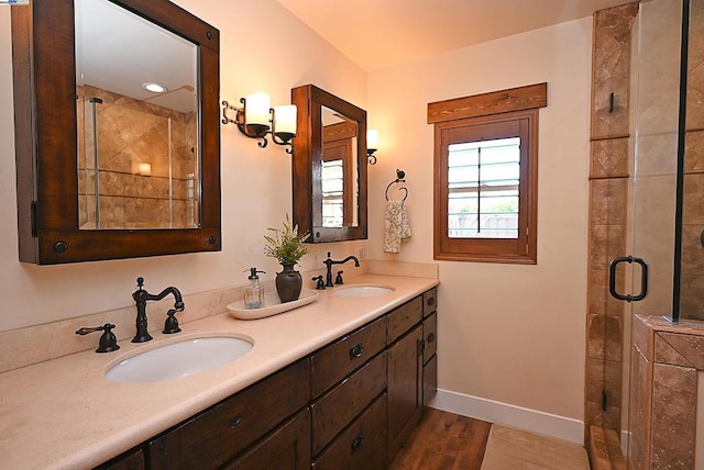 bathroom featuring vanity, hardwood / wood-style floors, and a shower with shower door