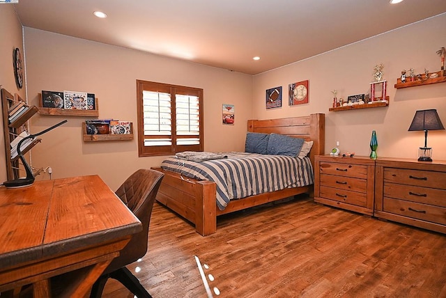 bedroom with hardwood / wood-style flooring