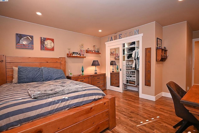 bedroom with hardwood / wood-style flooring and a closet