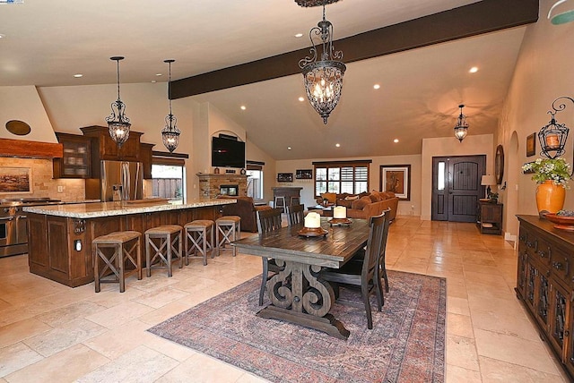 dining room with beam ceiling, a chandelier, and high vaulted ceiling