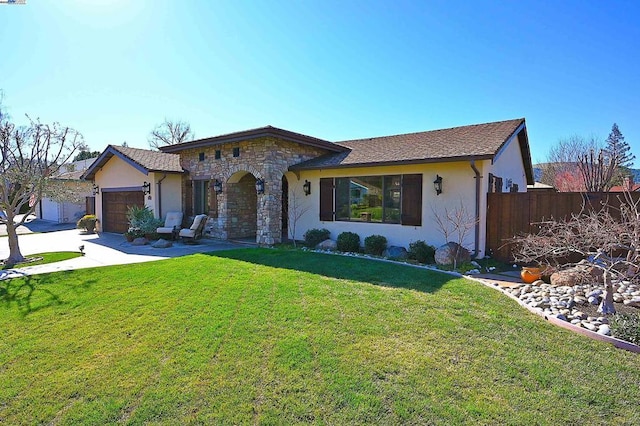 single story home with a garage and a front lawn