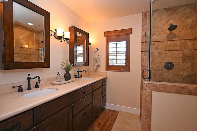 bathroom featuring vanity, wood-type flooring, and walk in shower