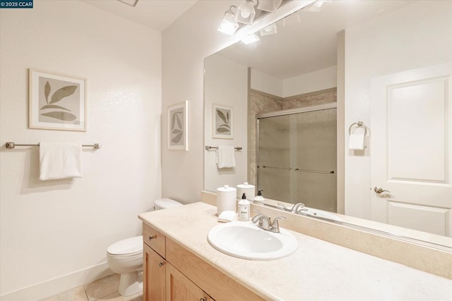 bathroom featuring tile patterned floors, toilet, a shower with shower door, and vanity