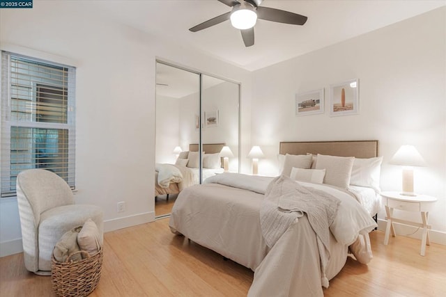 bedroom featuring ceiling fan, a closet, and light wood-type flooring