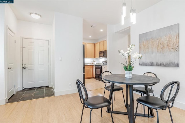 dining space with light hardwood / wood-style floors