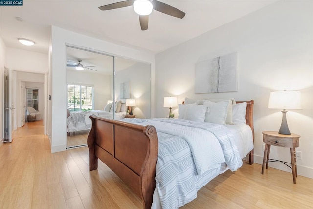 bedroom featuring ceiling fan, a closet, and light wood-type flooring