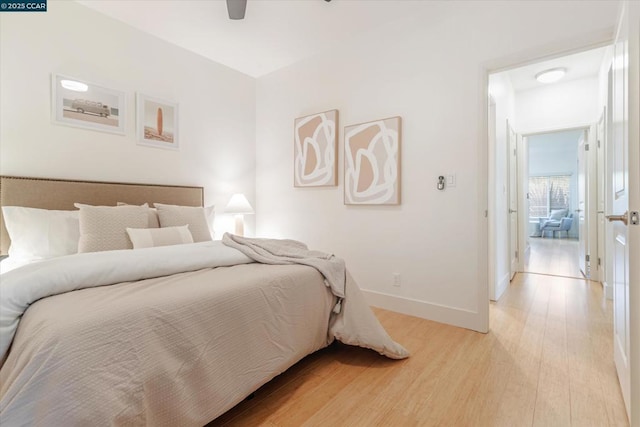 bedroom with ceiling fan and light wood-type flooring