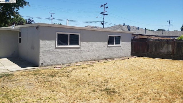 back of house with a lawn