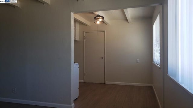 interior space featuring beamed ceiling, wood-type flooring, and a wealth of natural light