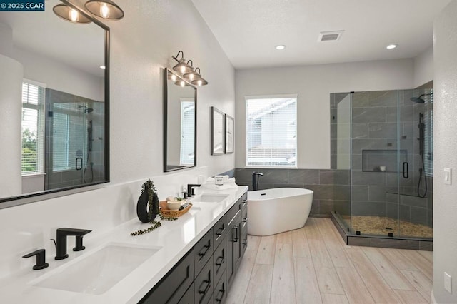 bathroom with vanity, hardwood / wood-style flooring, and separate shower and tub