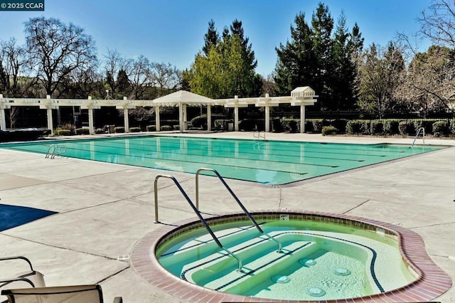 view of swimming pool with a hot tub and a patio