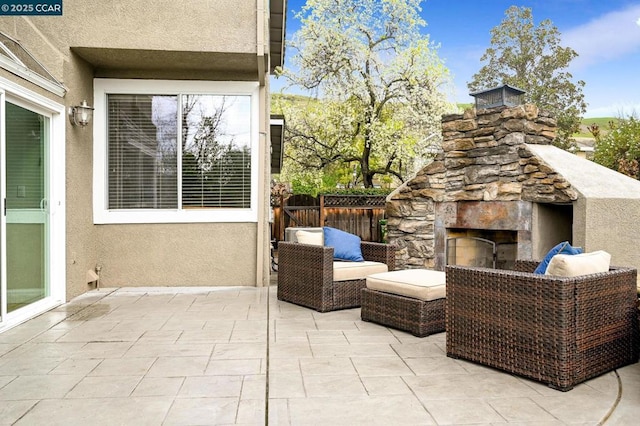 view of patio featuring an outdoor stone fireplace