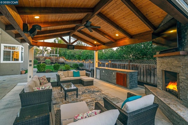 view of patio / terrace with an outdoor living space with a fireplace, a gazebo, and ceiling fan