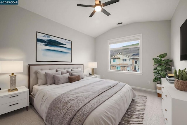 bedroom with lofted ceiling, light colored carpet, and ceiling fan