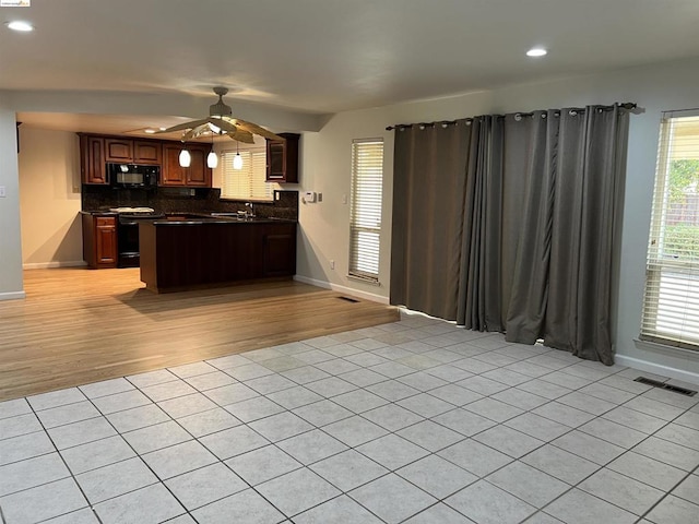 kitchen with sink, light tile patterned floors, ceiling fan, range with electric stovetop, and decorative backsplash