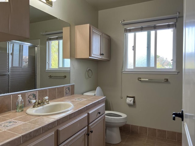 bathroom with vanity, an enclosed shower, tile patterned floors, and toilet