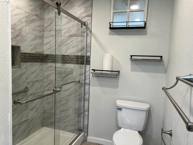 bathroom with toilet and walk in shower