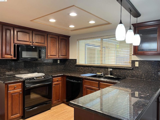 kitchen with sink, decorative backsplash, light hardwood / wood-style floors, and black appliances