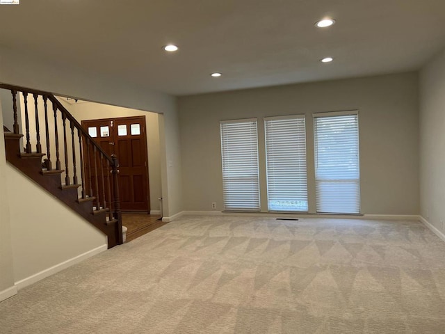 foyer featuring light carpet