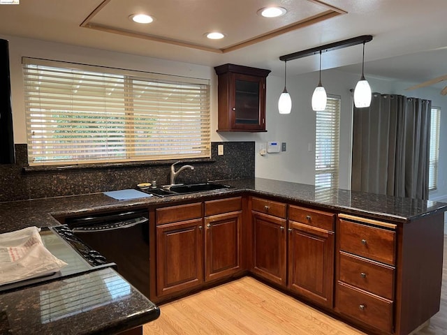 kitchen with a wealth of natural light, kitchen peninsula, and dishwasher