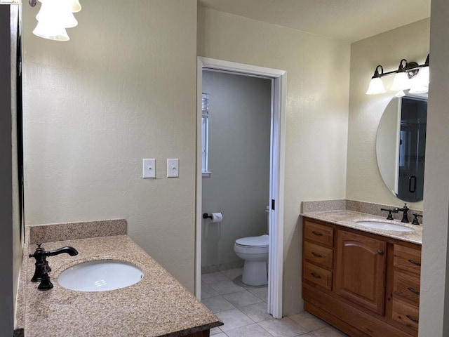 bathroom featuring tile patterned flooring, vanity, and toilet