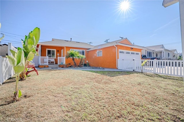 back of house with a garage and a lawn