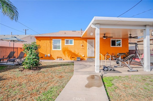 rear view of house with a patio and ceiling fan